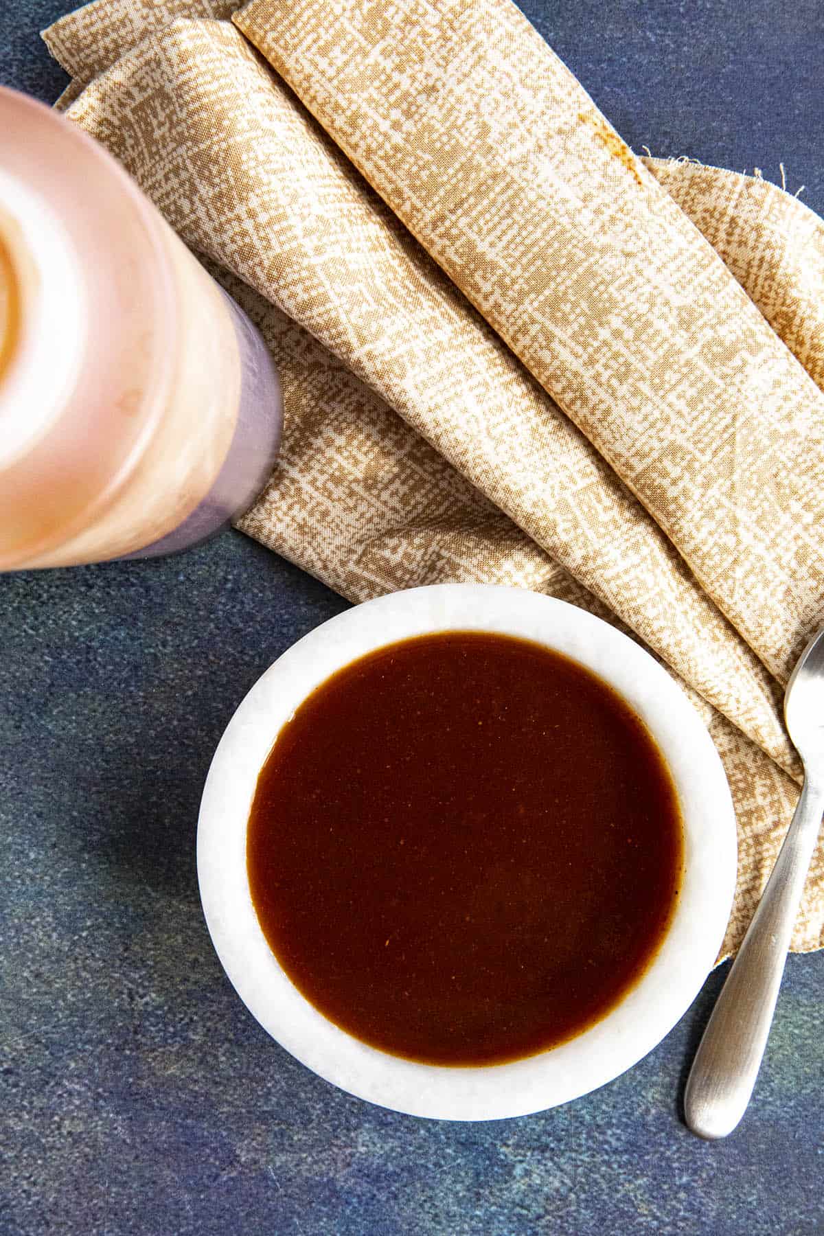 Homemade Mumbo Sauce in a bowl and a squeeze bottle