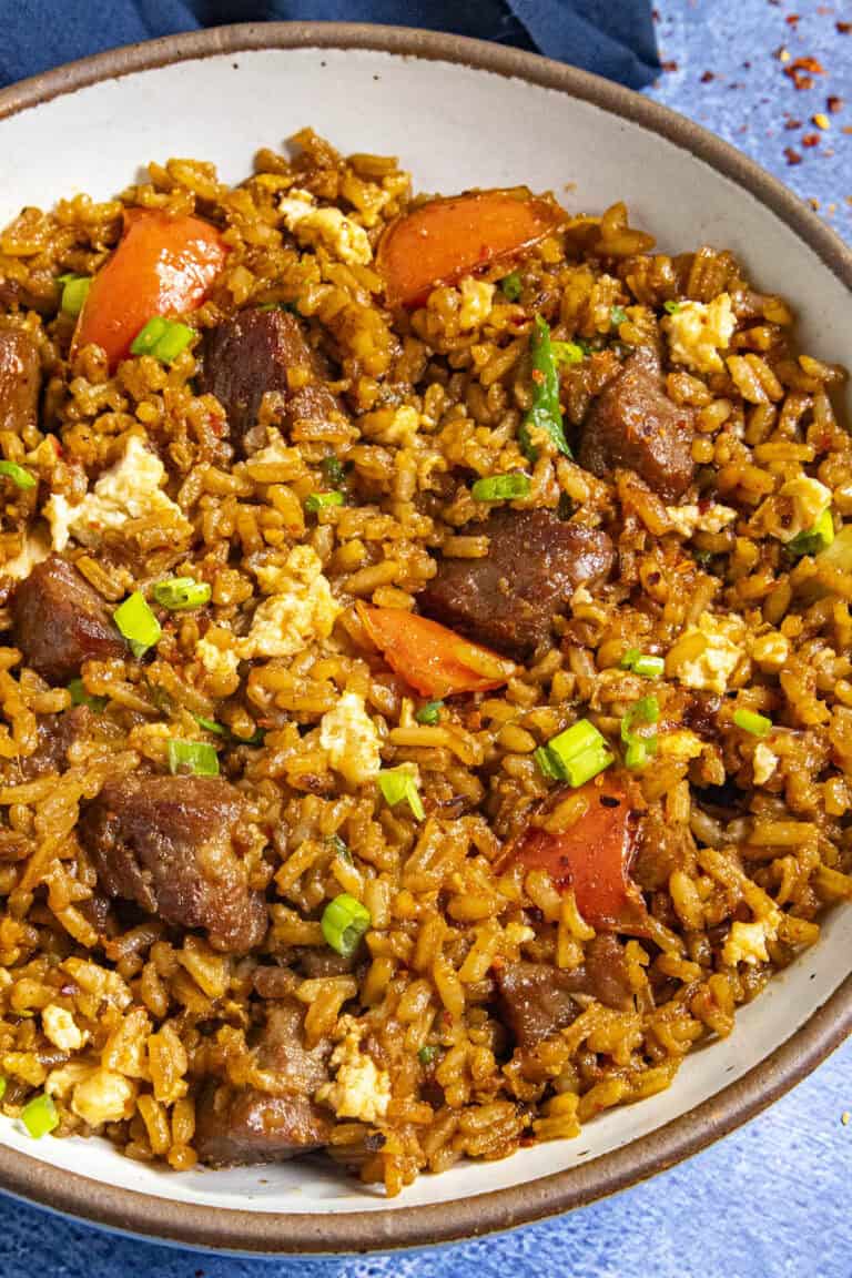 A bowl of Steak Fried Rice with lots of sizzling beef