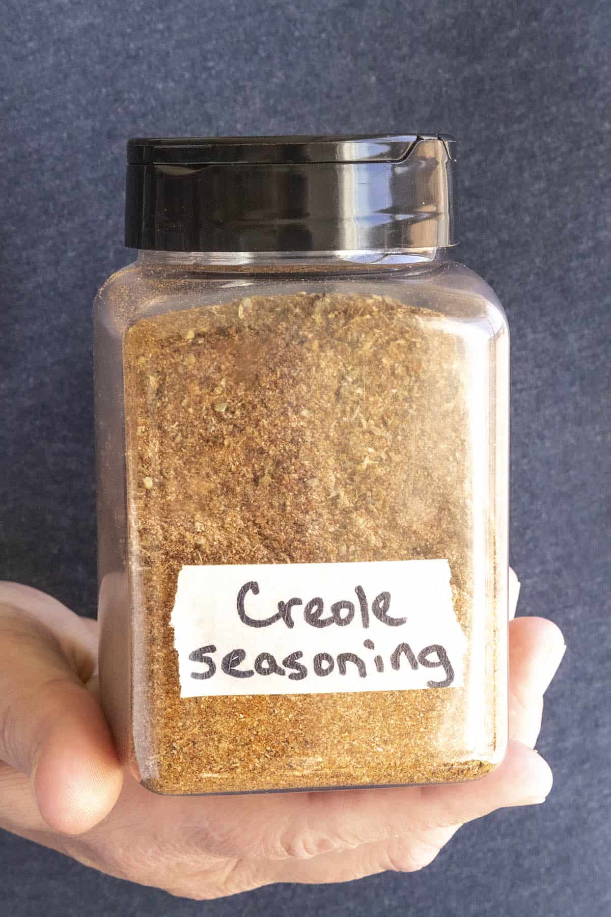 Mike holding a spice jar full of Homemade Creole Seasonings