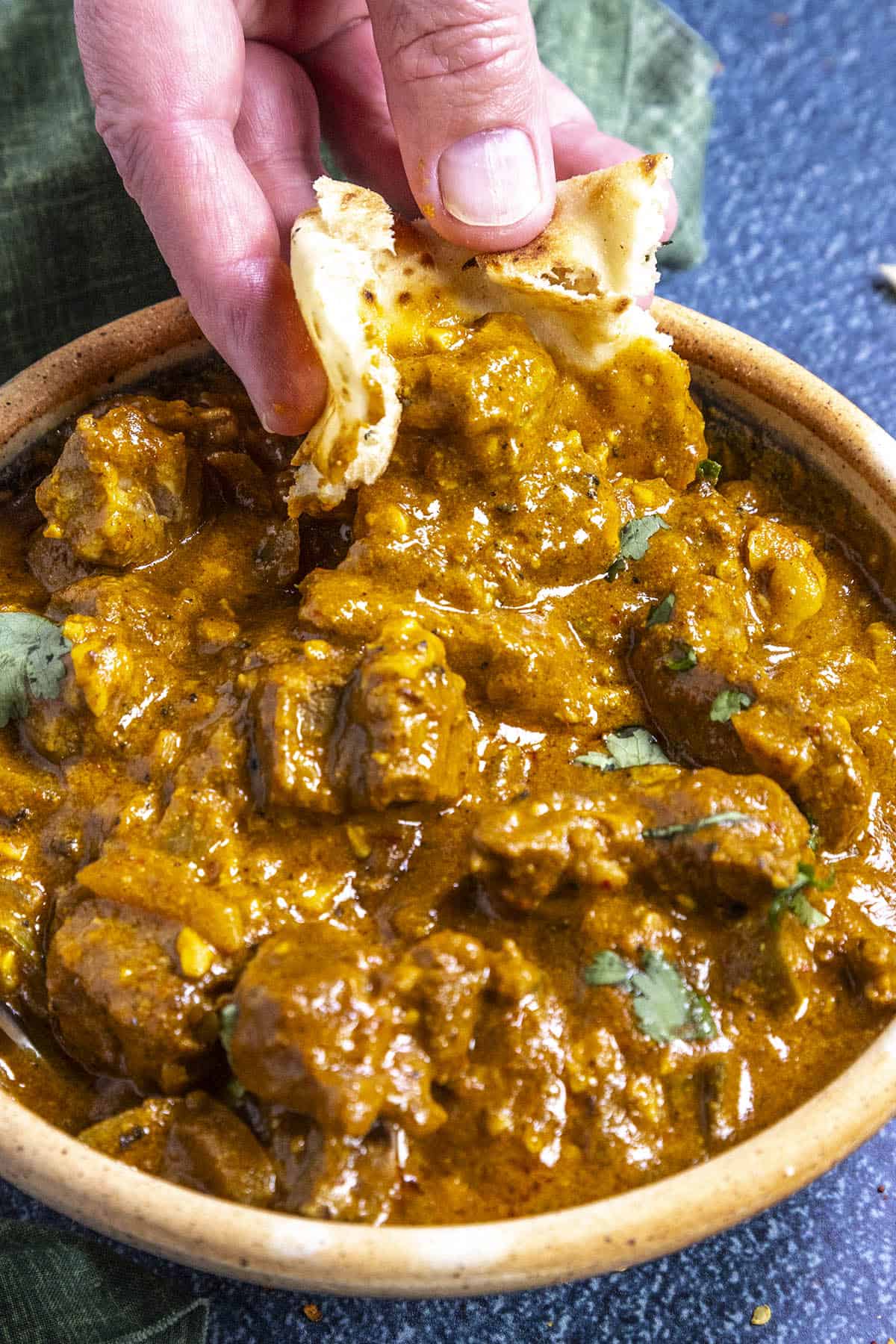 Mike sopping up Lamb Korma sauce with naan