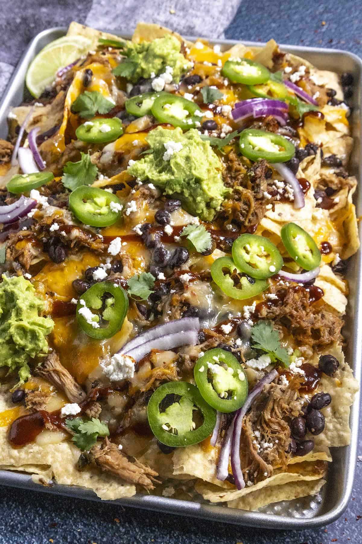 Pulled Pork Nachos on a baking sheet