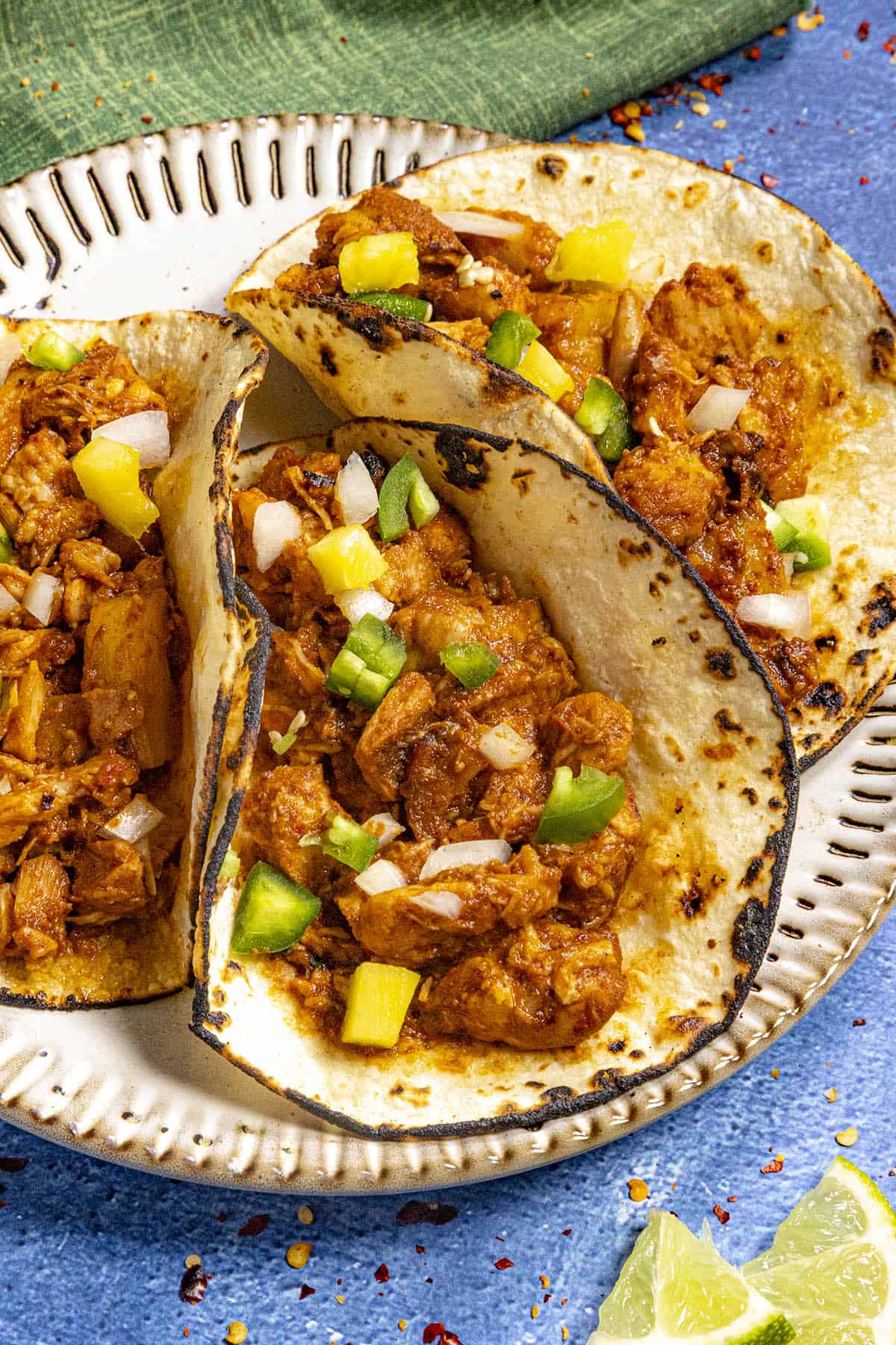 3 Chicken al Pastor tacos on a plate, ready to be enjoyed.
