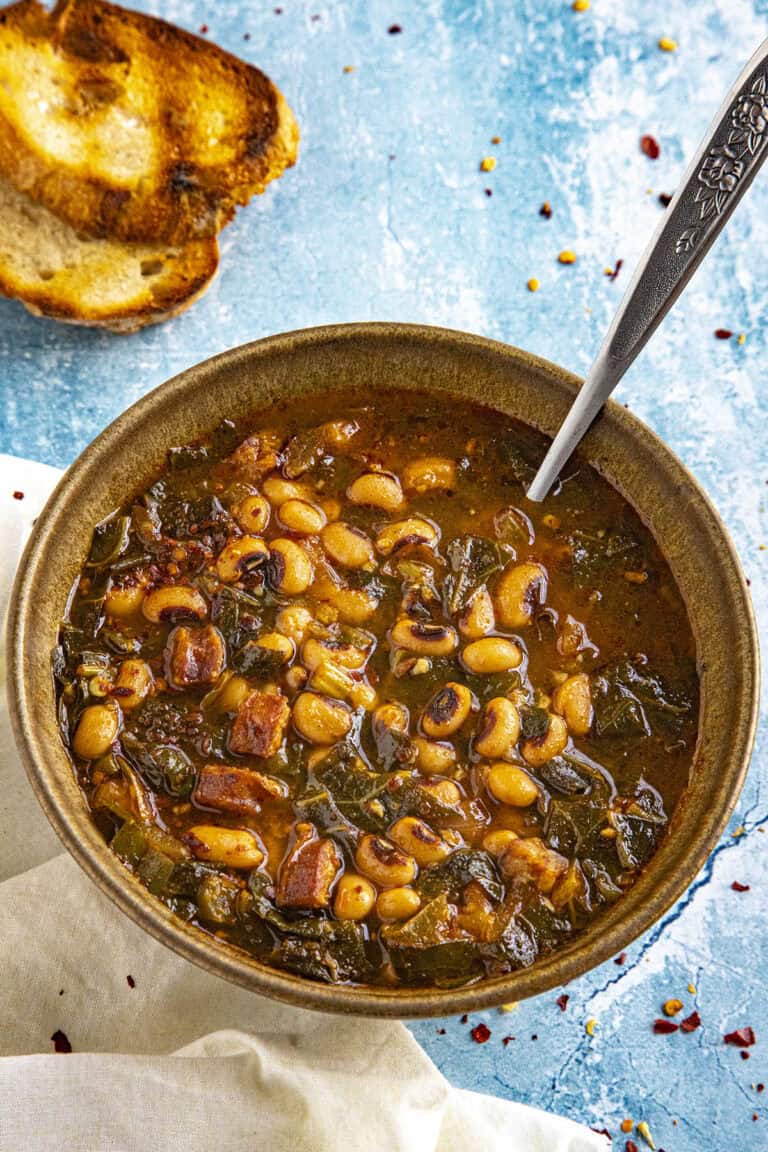 A bowl of Black Eyed Peas Soup served with grilled crusty bread for sopping