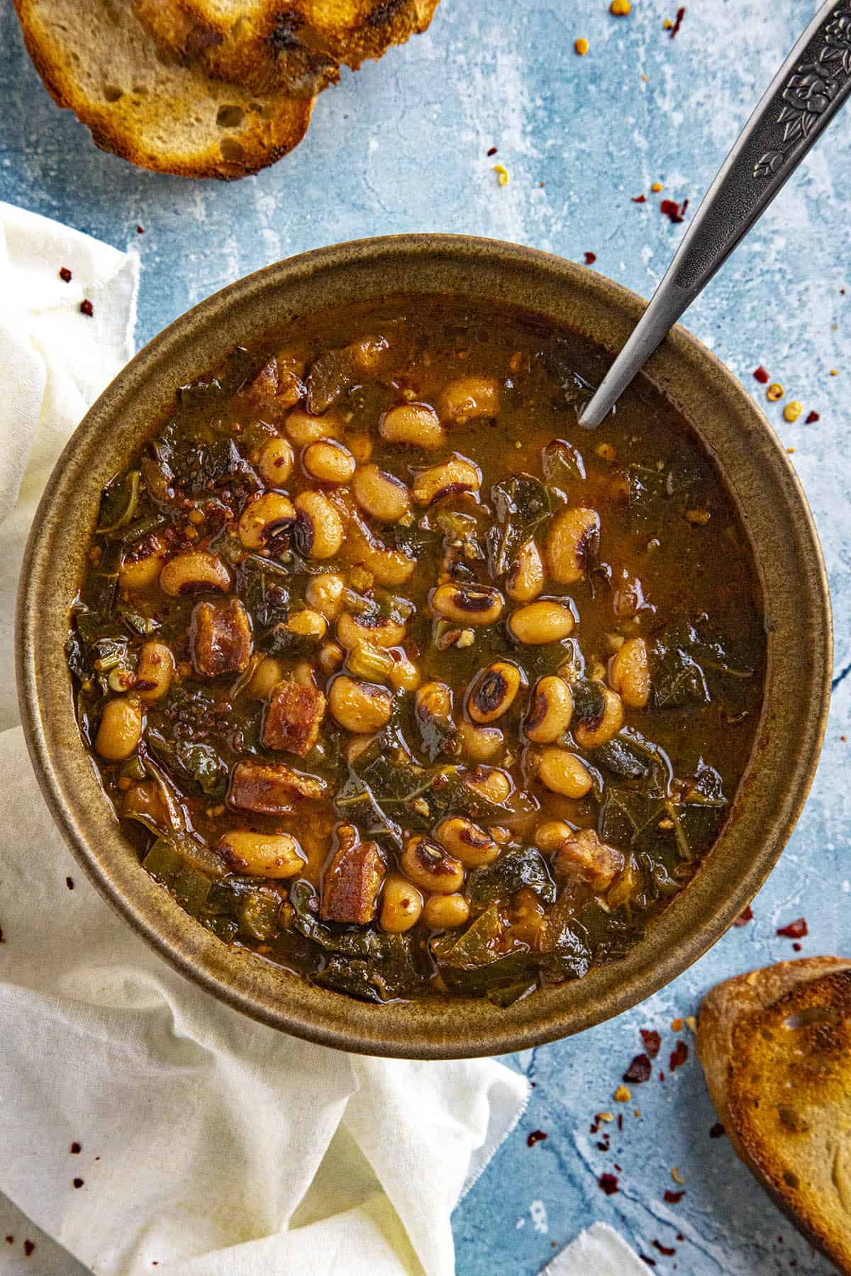 Black Eyed Peas Soup in a bowl with a spoon, served with grilled crusty bread