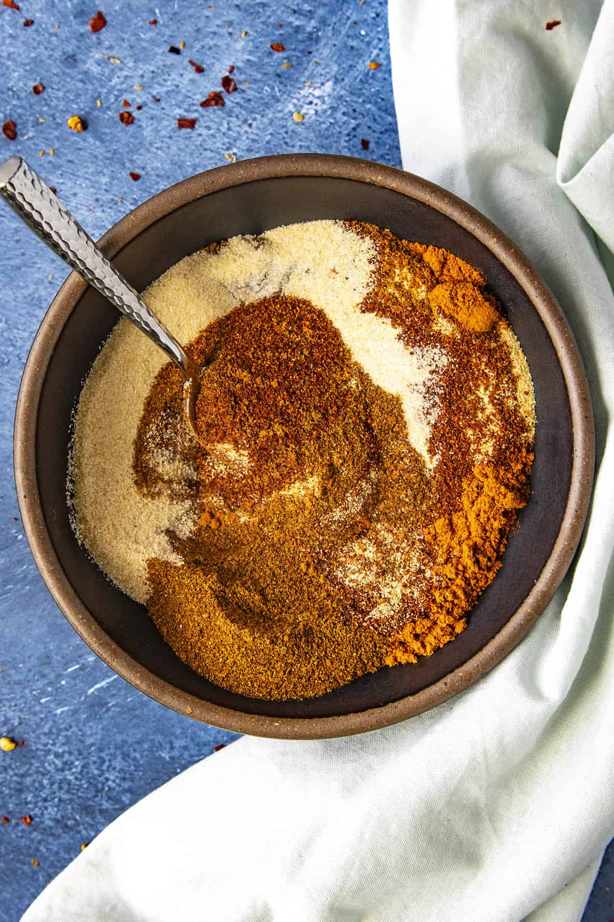 Mixing together Homemade Chili Powder ingredients in a bowl