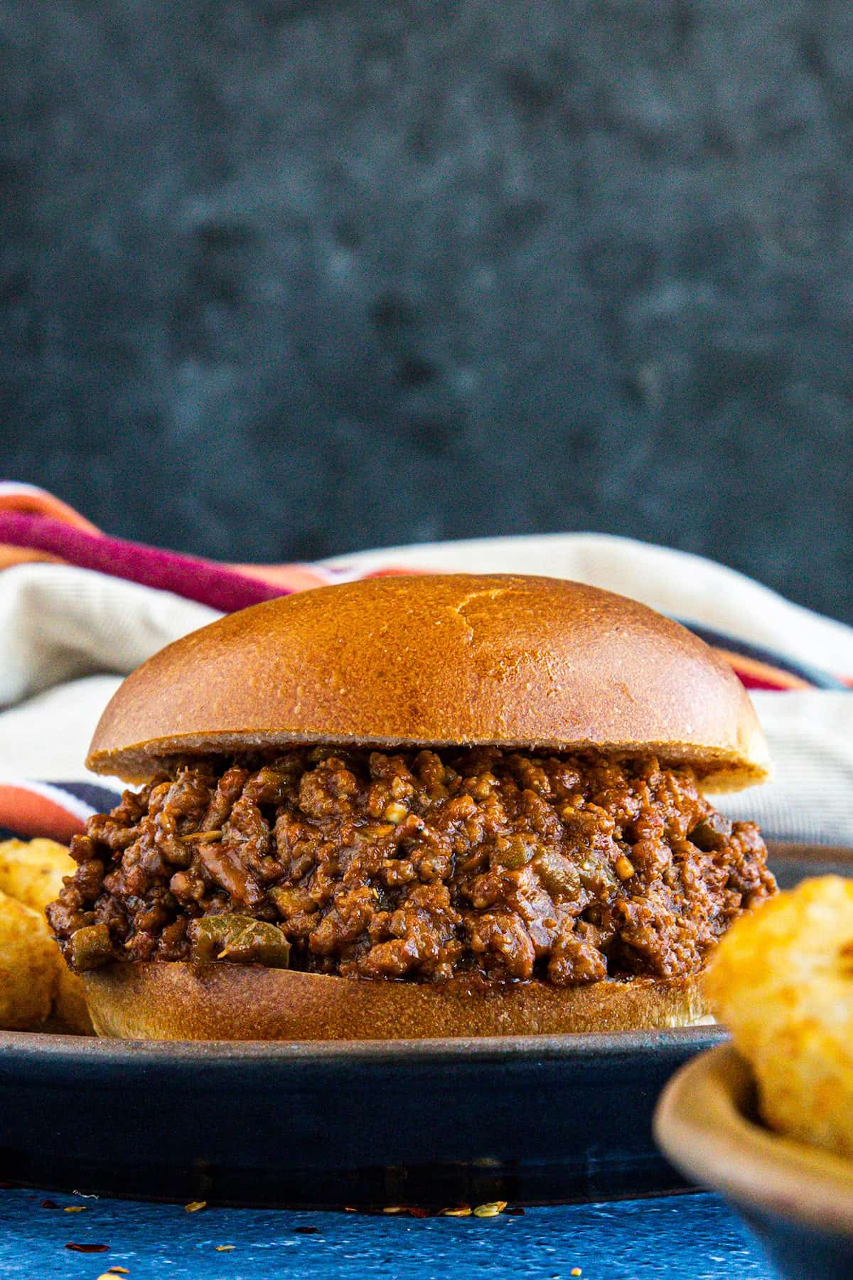 A Sloppy Joe sandwich with lots of saucy meat on the bun