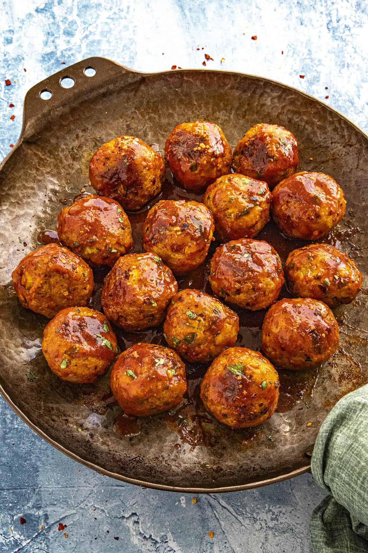 Mike serving Honey Sriracha Meatballs in a pan