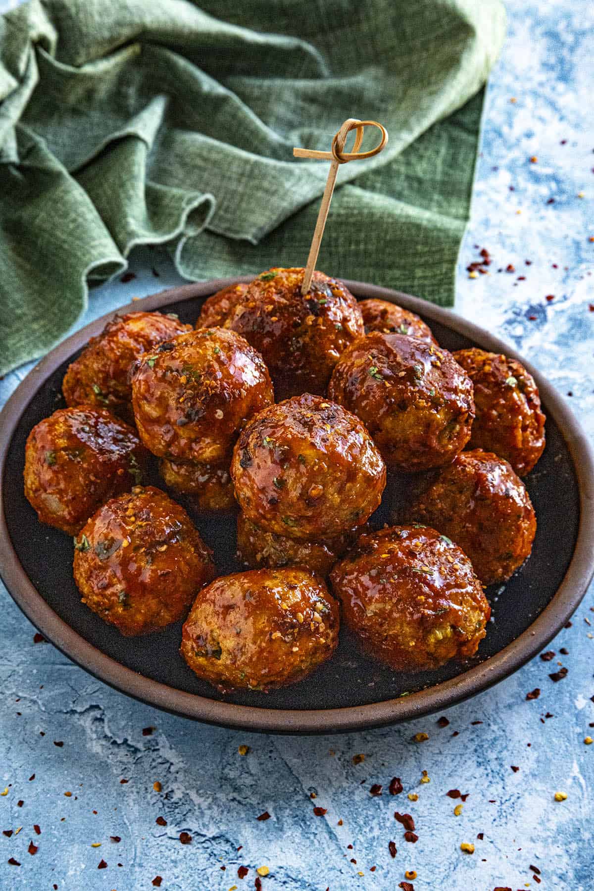 Honey Sriracha Meatballs served on a plate drizzled with extra glaze