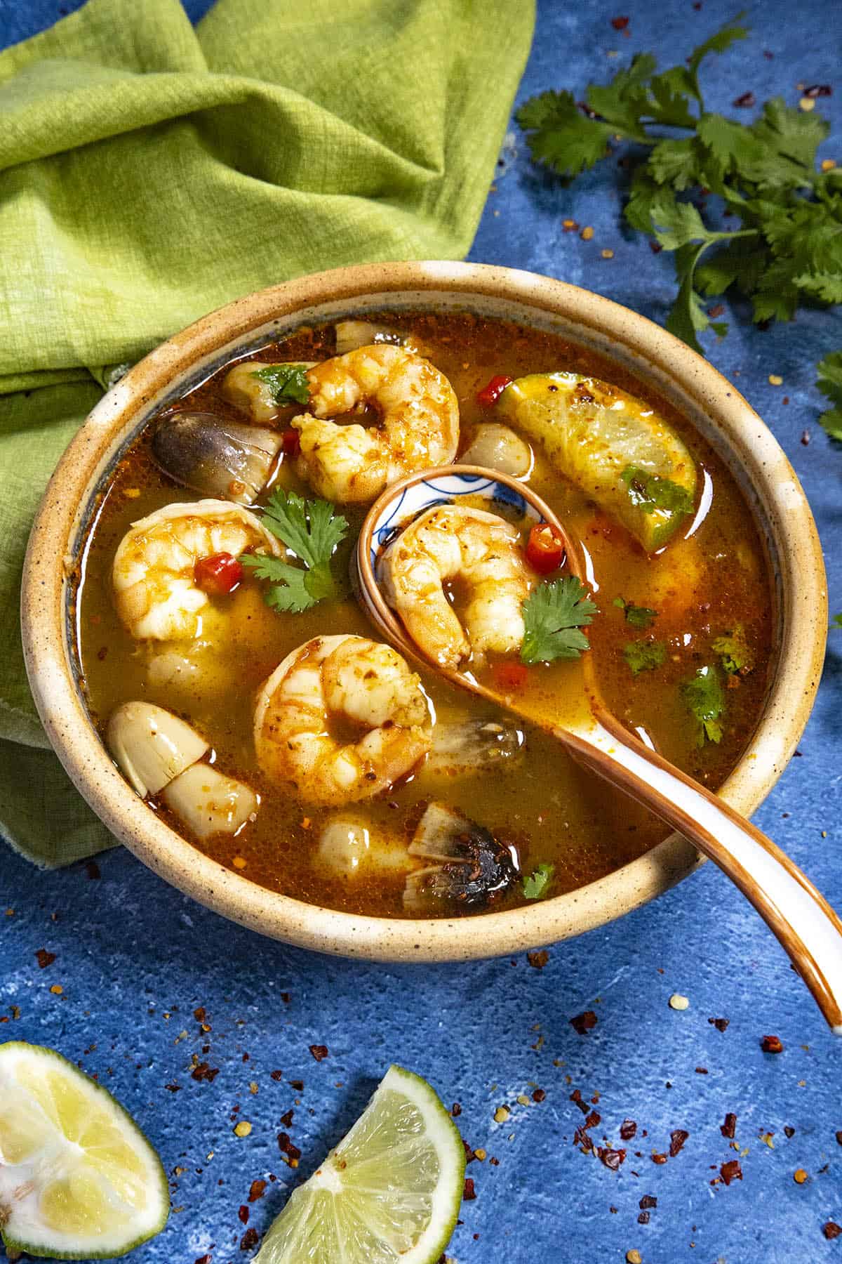 Mike taking a spoonful of Tom Yum Soup from the bowl