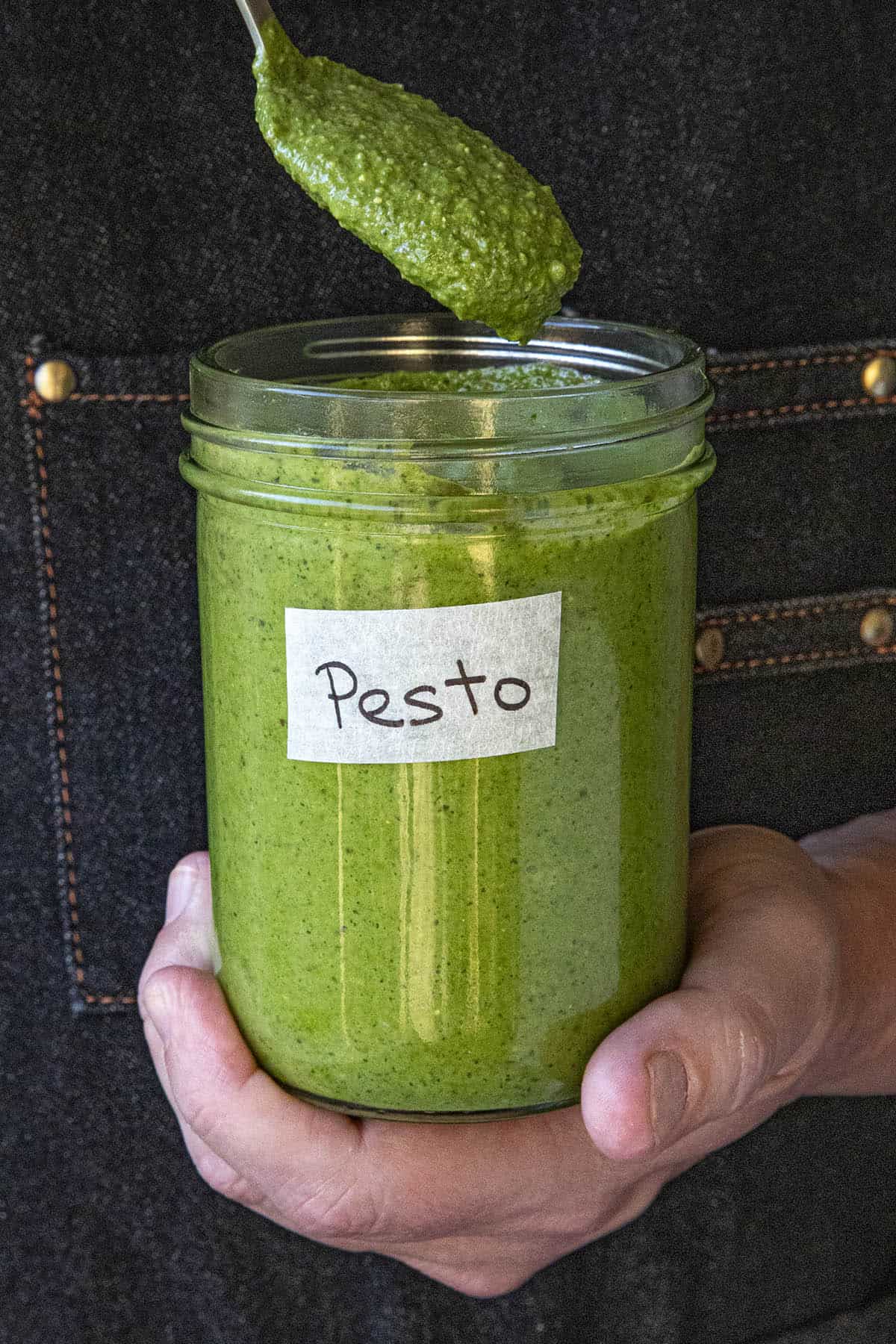 Mike holding a jar of homemade pesto