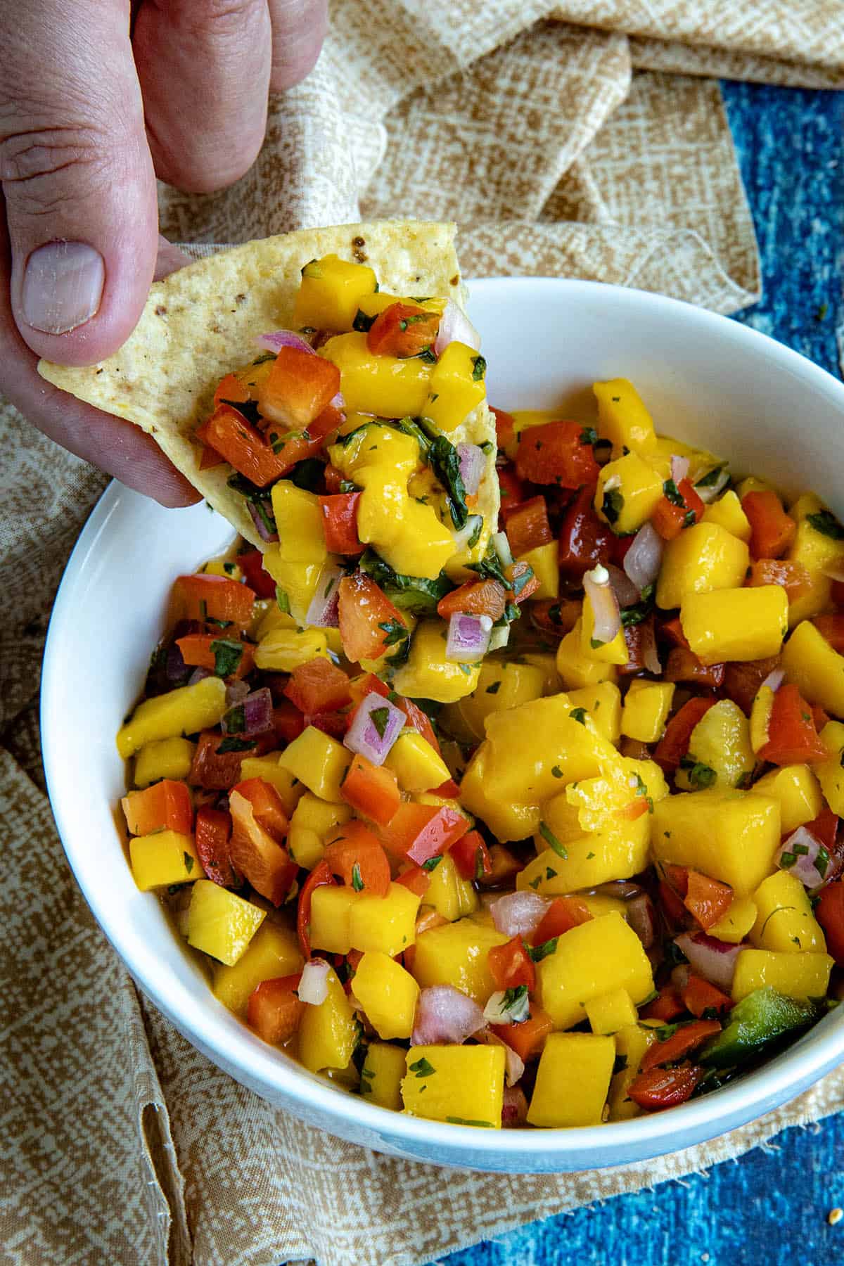 Mike scooping up some delicious Mango Salsa from the bowl with a tortilla chip