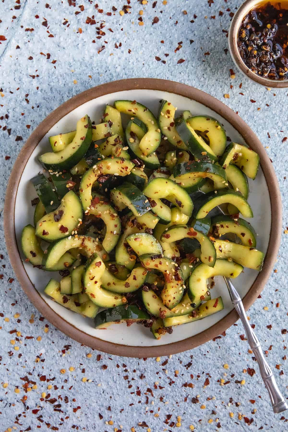 A large bowl filled with Sichuanese Spiced Cucumber Salad (Qiang Huang Gua)