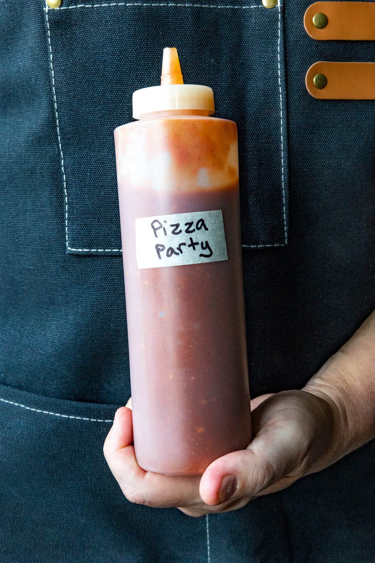 Mike holding a bottle of Pizza Party Hot Sauce