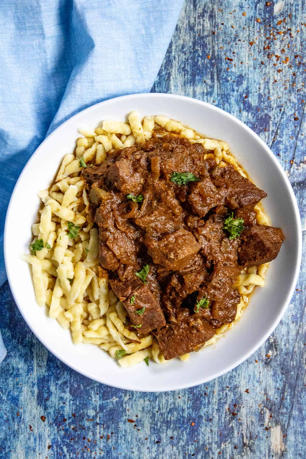 A bowl of Hungarian Porkolt served over nokedli (noodles)