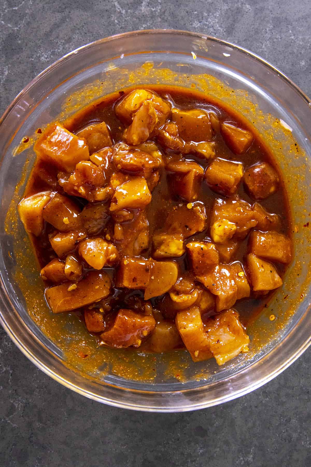 Marinating chicken in a bowl to make Gochujang Chicken