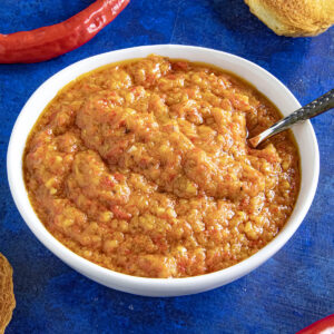 Ajvar (Serbian Roasted Red Pepper Relish) in a bowl with a spoon