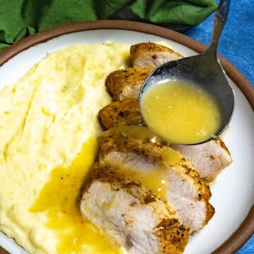 Mike ladling Roasted Garlic Gravy over sliced turkey and mashed potatoes