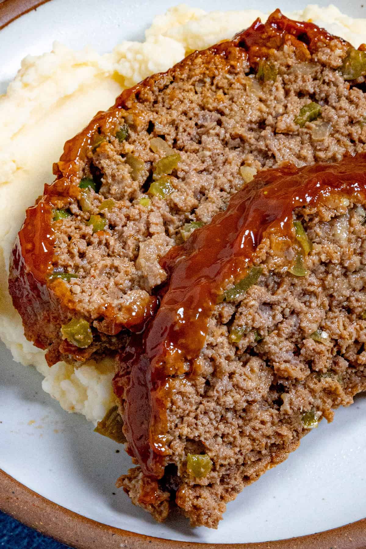 2 slices of southern style meatloaf served over mashed potatoes