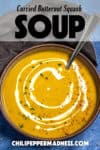 Curried Butternut Squash Soup served in a bowl, garnished with a cream swirl, fresh cilantro, and chili flakes