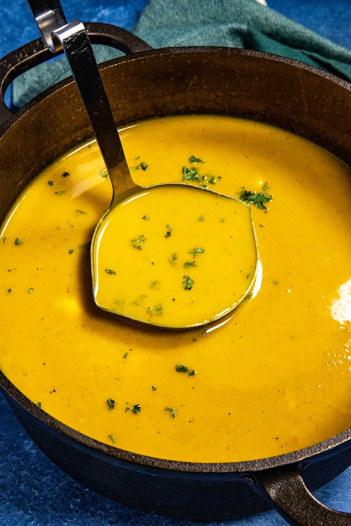 Mike taking a scoop of Curried Butternut Squash Soup from the stew pot