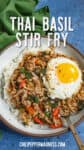 Pad Kra Pao (Thai Basil Stir Fry) in a bowl over rice, topped with a crispy fried egg