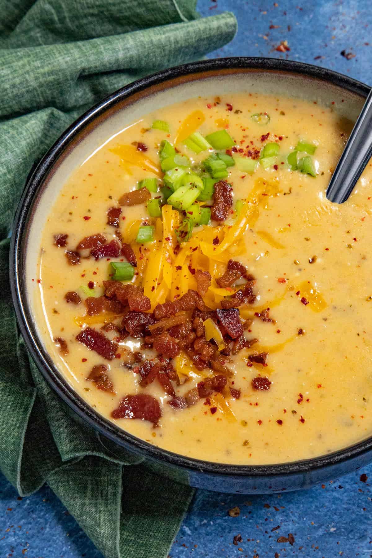 Like a baked potato in a bowl, creamy potato soup garnished with crumbled bacon, chives, and shredded cheddar cheese
