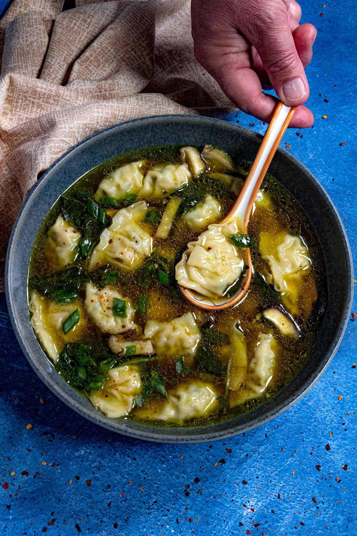 Easy Wonton Soup in a bowl, ready to serve, garnished with chopped green onion